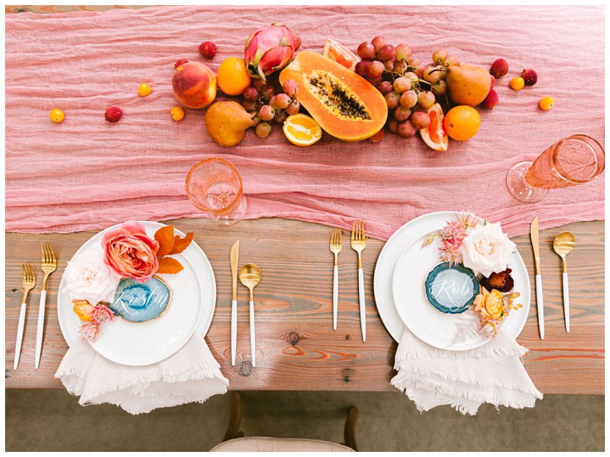 top shot of bride and groom place setting wit custom name plate and fruit spread decor | The Farmhouse Events Real Weddings | A Summer Vision of Love | Kristin & Rob