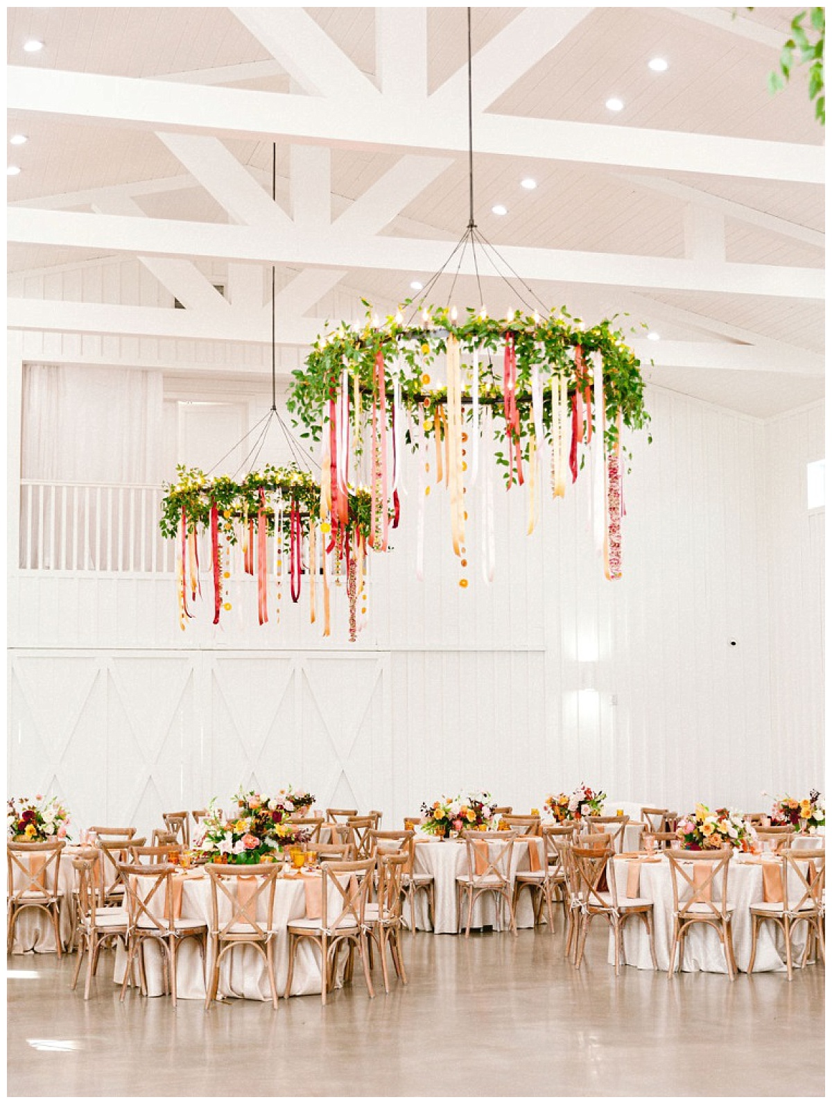 Full Reception space view of decorated tables and chadeliers | The Farmhouse Events Real Weddings | A Summer Vision of Love | Kristin & Rob