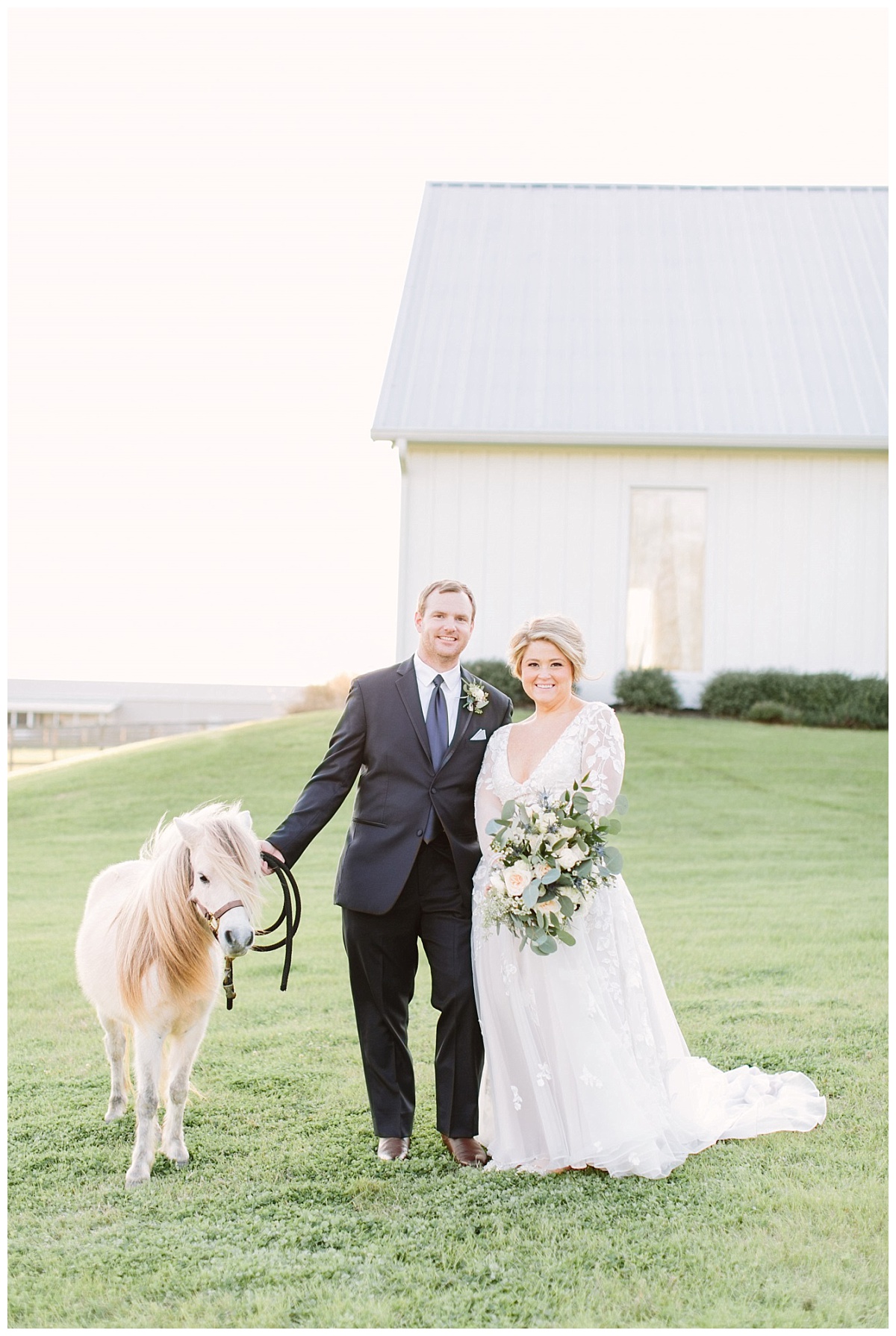Bride and groom with chapel in background with pony facing camera| The Farmhouse Events Real Weddings| A Little Something Blue| Kelly & Jarrod