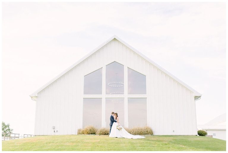 couple in embrace with a backdrop of backside of the chapel The Farmhouse Events Real Weddings| Montgomery TX| Christina & Eric